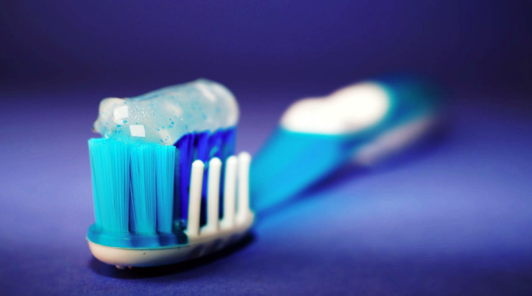 toothbrush with toothpaste on it that has microbeads in it.